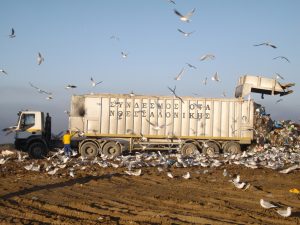 FODSA Iveco Trakker 6x4 prime mover discharging a 56m3 top loading ejector trailer from one of the waste transfer stations across Thessaloniki Prefecture at the tip face of the Mavrorahi sanitary landfill site.