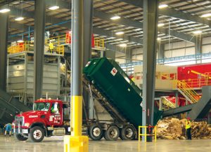 A Penn Waste recycle truck empties recyclables onto the tipping floor.