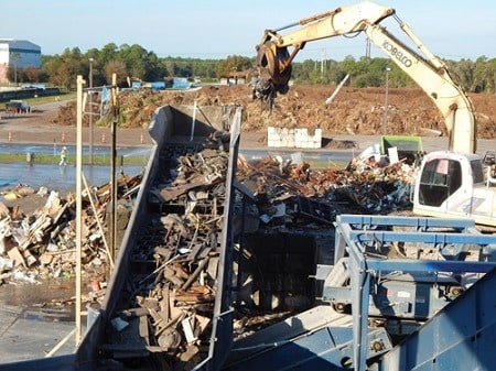 Separating waste materials at a processing facility