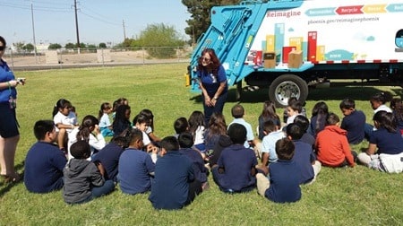 Reimagine Phoenix specialist gives a show-and-tell presentation on recycling and waste diversion to elementary school children.